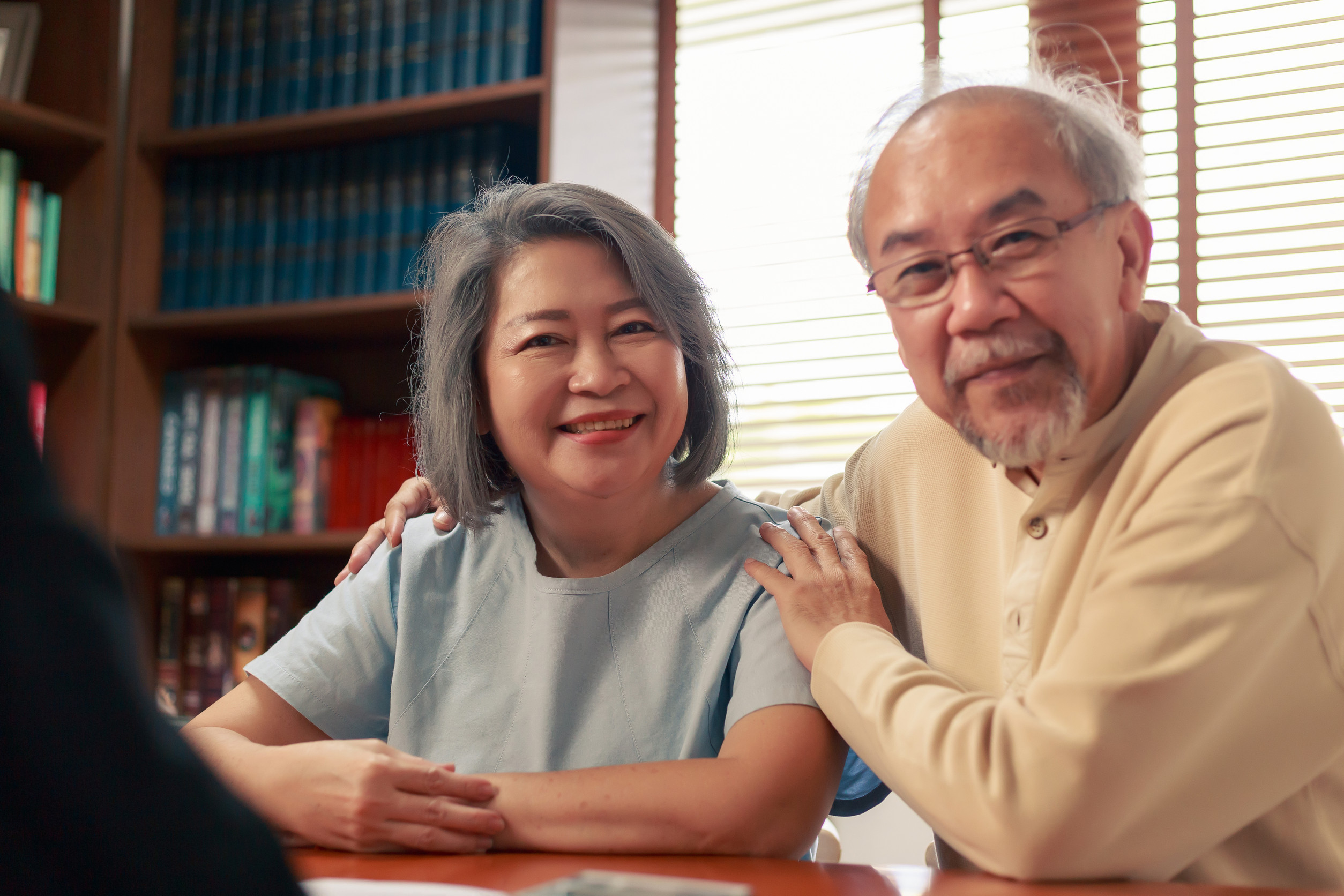 Happy Asian senior couple feel releif and pleasant after get the advice about family financial planning from professional financial advisor at home